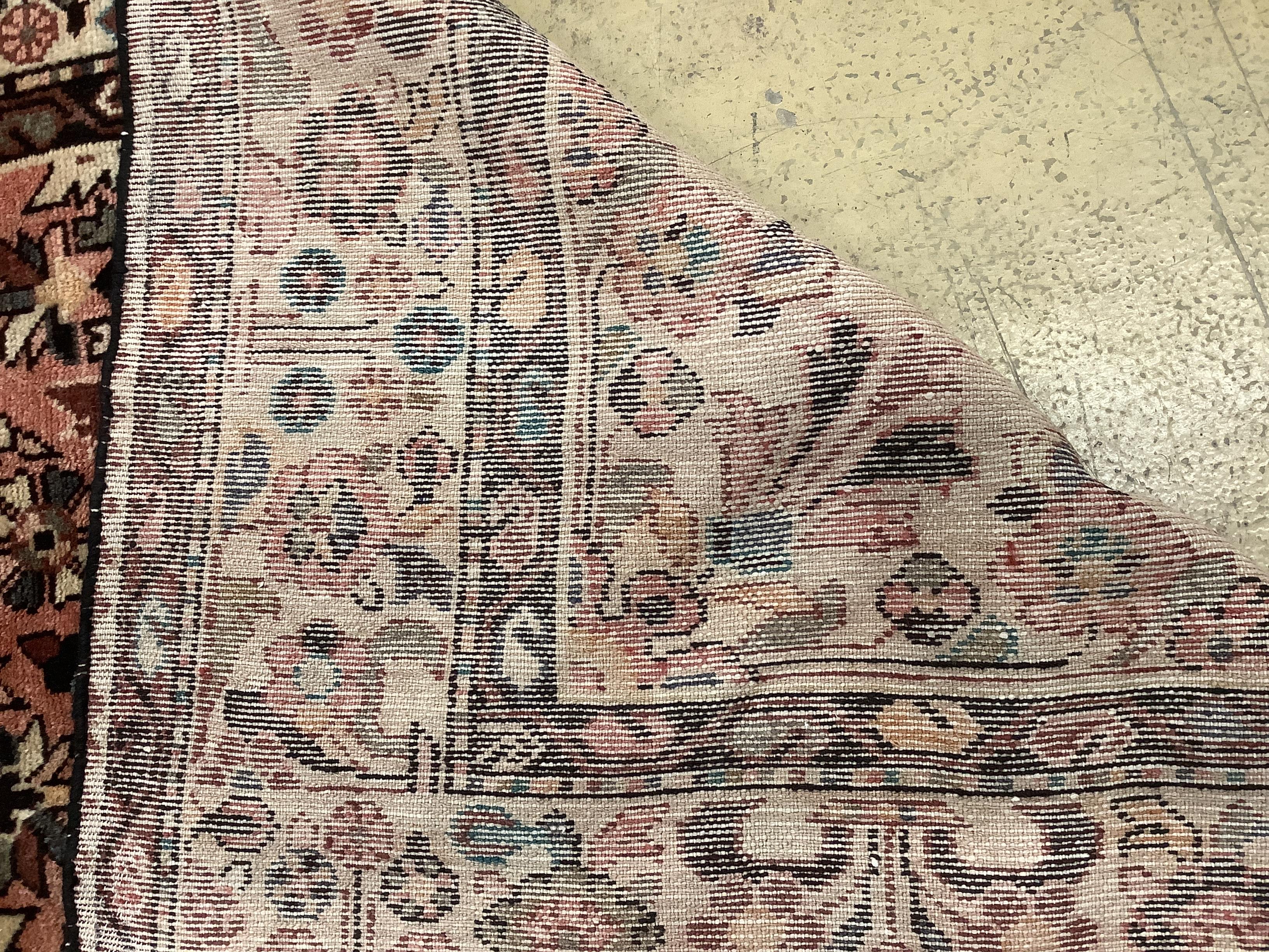 A Hussein Abad brick red ground carpet, 322 x 202cm